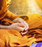 Buddhist monk with hands in lap